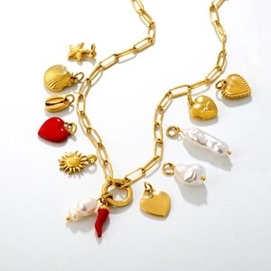 Golden paperclip chain necklace featuring pearl charms and red enamel heart pendant