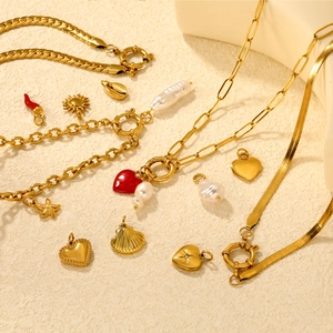 Detailed flat lay of 18K gold plated stainless steel heart and starfish pendant necklaces