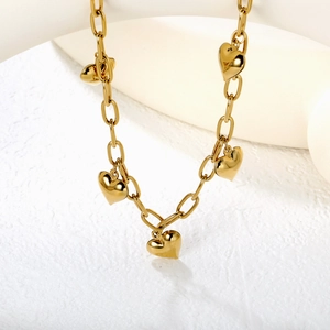 Detailed shot of 18k gold plated stainless steel paperclip chain with heart pendants