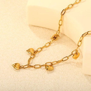 Golden stainless steel heart tassel necklace featuring four polished mirror heart pendants