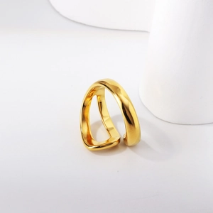 Close-up of a double-layered wavy gold ring with a polished geometric mirror finish