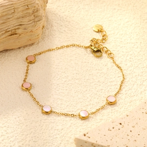 Detail view of 18K gold plated snake chain with five circular cat-eye stone inlays