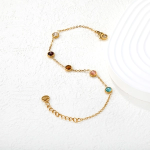 Gold chain bracelet featuring five vibrant round colorful gems and a secure lobster clasp