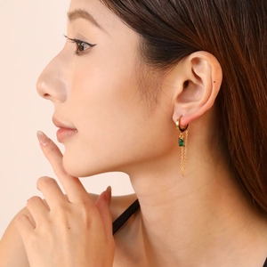 18K gold plated chain drop earrings with emerald zircon on elegant female model