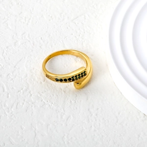 Detailed close-up of a gold-plated open ring featuring a row of emerald green zircon stones