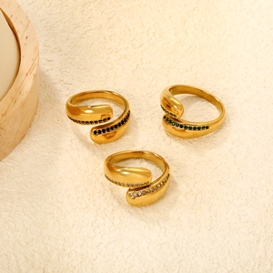 Detailed macro shot of vintage emerald and zircon irregular rings in gold plating