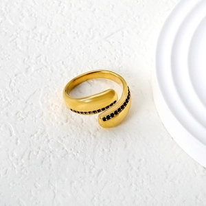 Detail of vintage gold bypass ring with intricate black pavé crystal setting