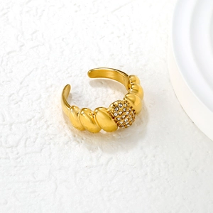 Macro view of gold twisted emerald-cut style ring with sparkling micro-pave zircons
