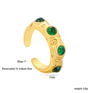 Detail of 18k gold plated adjustable ring featuring four green stones and lava texture