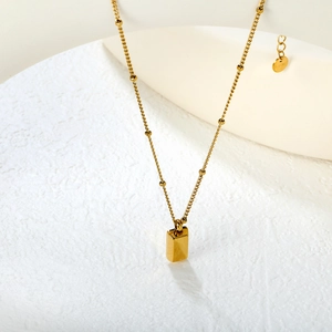 Minimalist gold stainless steel beaded necklace with sleek rectangular bar pendant