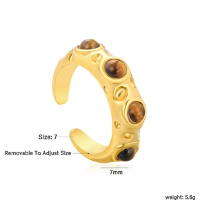Detail of gold hammered ring with round tiger eye stones and size adjustment feature