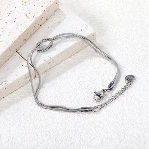 Detail of a double-layered stainless steel snake chain bracelet with a knot design