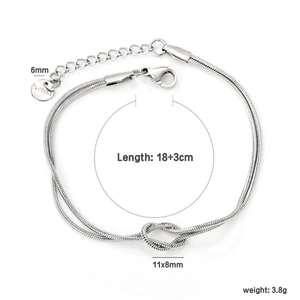 Detail view of double-layer stainless steel heart knot bracelet with S.Steel tag