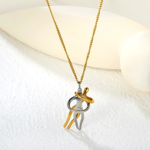 Minimalist gold and silver hugging figures pendant necklace on an artistic white background