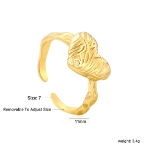 Detail of adjustable golden heart ring with irregular texture and size dimensions
