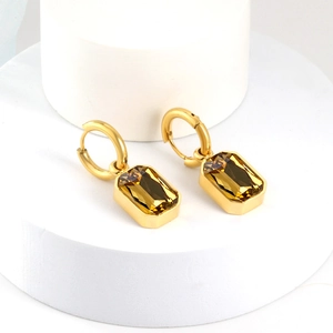 Detail of 18K gold plated drop earrings with rectangular amber-colored crystals