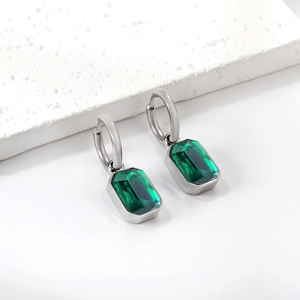 Detail of emerald green rectangular crystal earrings with polished silver metal hoops