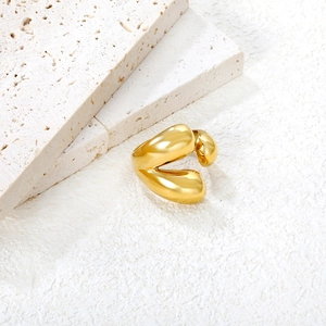 Irregular fluid waterdrop open ring in 18K gold plated stainless steel on travertine