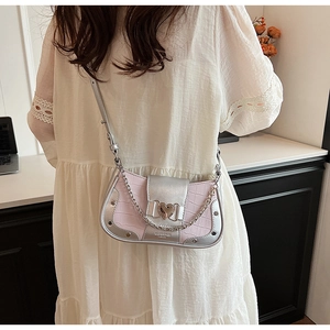 Detail of pink croc-embossed leather handbag with silver trim and heart-shaped metal buckle