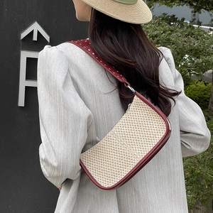 Straw baguette underarm bag with burgundy leather trim and silver studded shoulder strap
