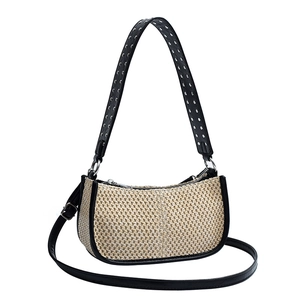 Fashionable woven straw underarm bag with black leather trim and metal rivet strap