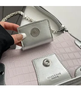Close-up of pink crocodile texture leather with silver magnetic clasp and chain detail