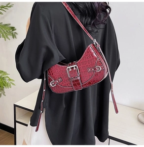 Détail du sac sous le bras bordeaux à motif crocodile avec boucle carrée argentée