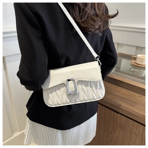 Detail of white pleated PU leather crossbody bag with silver geometric buckle on model