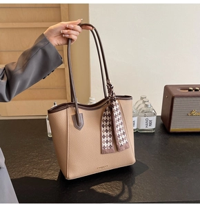 Detail of beige large tote bag with lychee grain leather and vintage plaid silk scarf handle