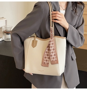 Close-up of large capacity beige tote bag with litchi grain leather and silk handle scarf