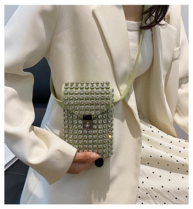 Dettaglio della mini borsa a tracolla verde chiaro con strass e chiusura in metallo argento