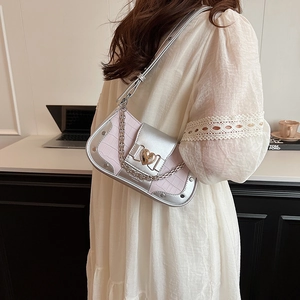 Pink croc-embossed underarm bag with silver chain and gold heart buckle detail