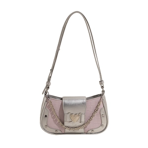 Pink croc-embossed underarm bag with heart buckle and silver chain in Y2K style