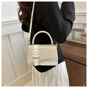 Detail of white stone pattern small square bag featuring metal buckle and strap