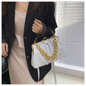 Detailed shot of white ruched cloud bag with vintage gold kiss-lock and chunky chain handle