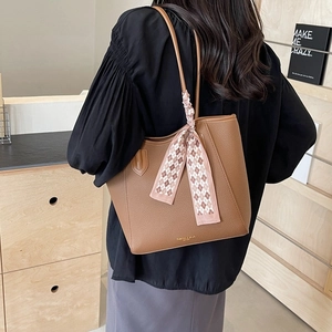 Brown litchi texture large tote bag with silk scarf accessory on a shoulder strap