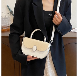Detail of the chic saddle bag featuring contrast weaving texture and silver buckle