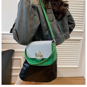 Green leather crossbody bag with blue and white textured flap worn by model