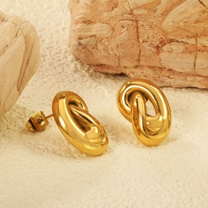 Close-up of gold plated heart heart earrings on natural stone for a premium look