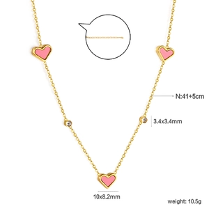 Detail of pink heart pendants and clear stones on a gold stainless steel necklace