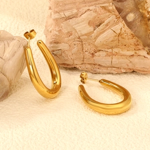 Polished 18K gold stainless steel thick U-shaped drop earrings on natural stone