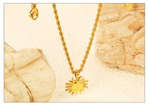 Detail of 18K gold plated stainless steel sun pendant with thick twist rope chain