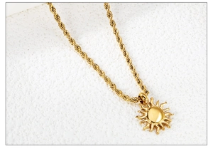Detail of 18K gold-plated stainless steel sun pendant with thick rope chain design