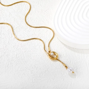 Gold snake chain necklace with minimalist geometric ring and double pearl pendant charms
