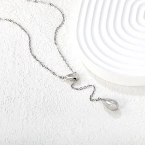 Minimalist silver-toned Y-shaped necklace with dual waterdrop pendants on a cross chain