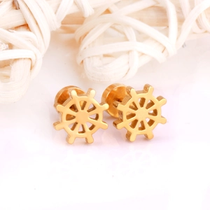 Detailed close-up of gold nautical helm stud earrings made of stainless steel