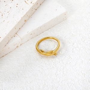 Detail of 18K gold plated stainless steel twisted ring with small metal beads on stone