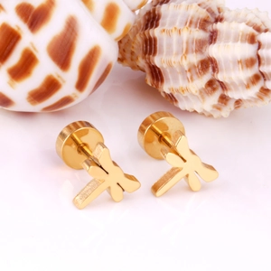 Detailed view of dragonfly-shaped golden stainless steel stud earrings on shells