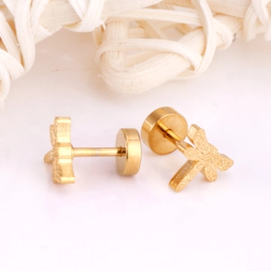 Macro shot of gold dragonfly stud earrings with a matte finish and secure backings