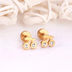 Close-up of gold-plated cherry earrings featuring sparkling white zircon stones